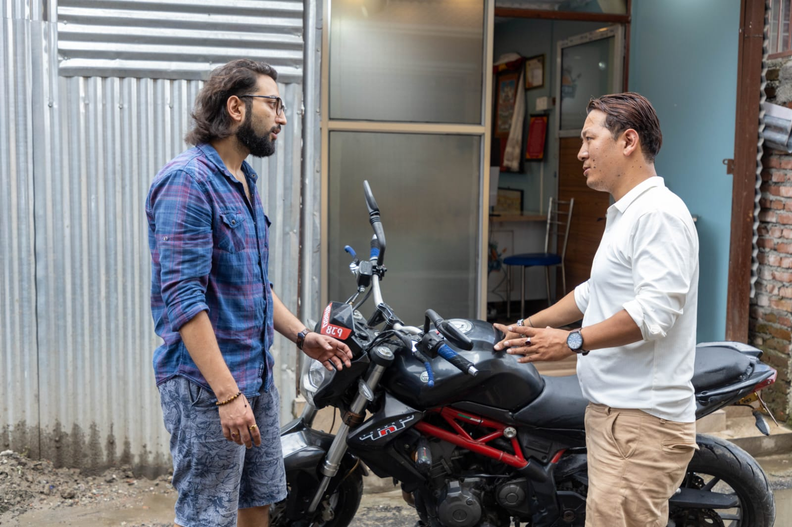 Mechanic inspecting car dent repair and painting services